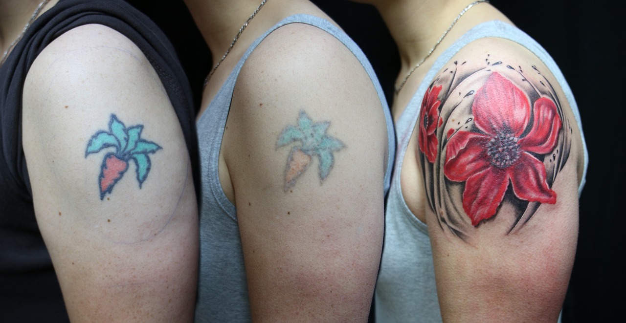 Three stages of the same shoulder tattoo, fading from bold colour to a faint outline (stock photo)