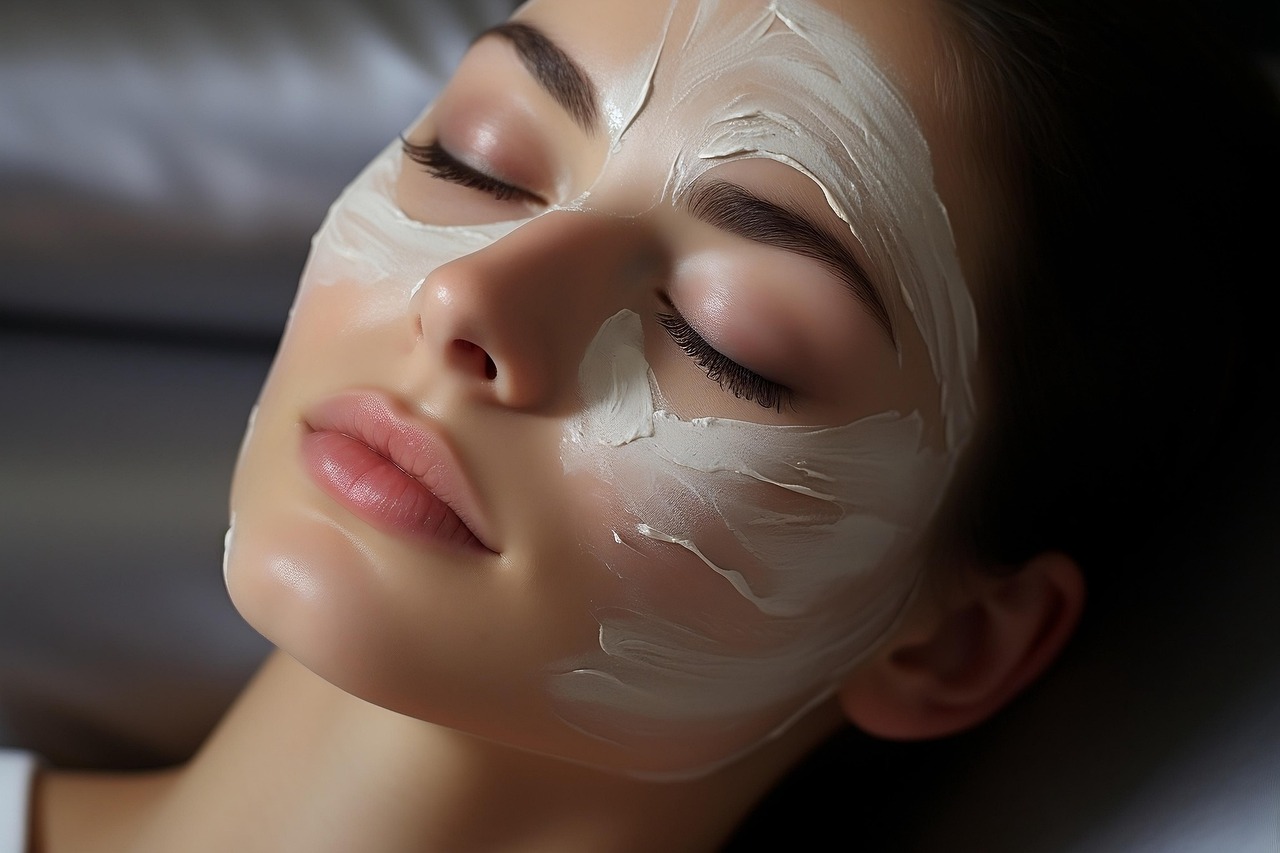 A woman relaxing with a cream face mask applied