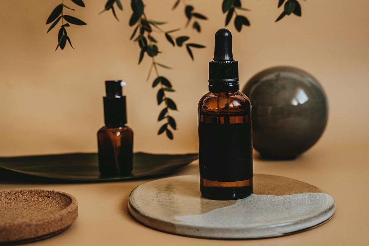 Amber dropper bottles of serum on a stone tray